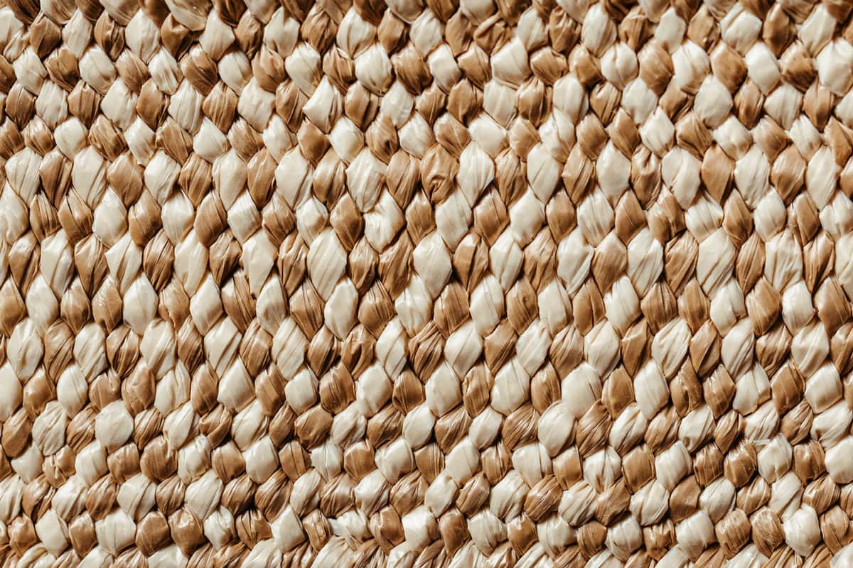 A jute rug and a sisal rug side by side showing texture differences